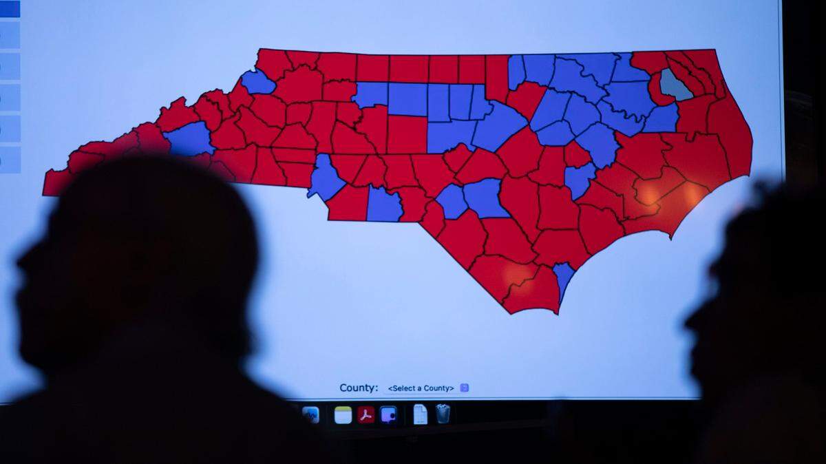 People stand in front of a live election results map of North Carolina during the Western Wake Republican Club’s election night watch party at Sophie’s Grill and Bar on Tuesday, Nov. 5, 2024, in Cary, N.C.