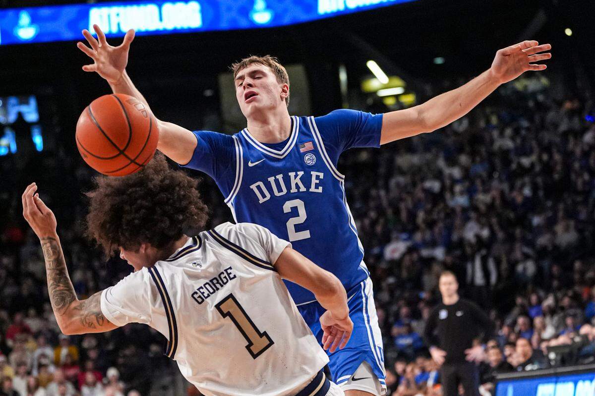 Duke Blue Devils guard Cooper Flagg (2) and Georgia Tech Yellow Jackets guard Naithan George (1) fight for the ball during the first half at McCamish Pavilion.