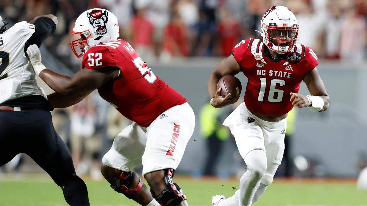 N.C. State offensive lineman Timothy McKay (52) opens a hole for quarterback MJ Morris (16) during the Wolfpack’s game against Wake Forest at Carter-Finley Stadium in Raleigh, N.C., Saturday, Nov. 5, 2022.