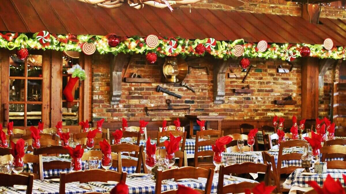 The large upstairs dining room at the Angus Barn in Raleigh has lights along the ceiling and even includes a large Santa sleigh. Photographed in November 2016.