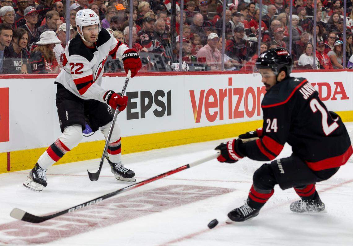 New Jersey DevilsÕ defenseman Bret Pesce (22) moves the puck past Carolina Hurricanes center Seth Jarvis (24) in the first period on Sunday, April 20, 2025 at Lenovo Center in Raleigh, N.C.