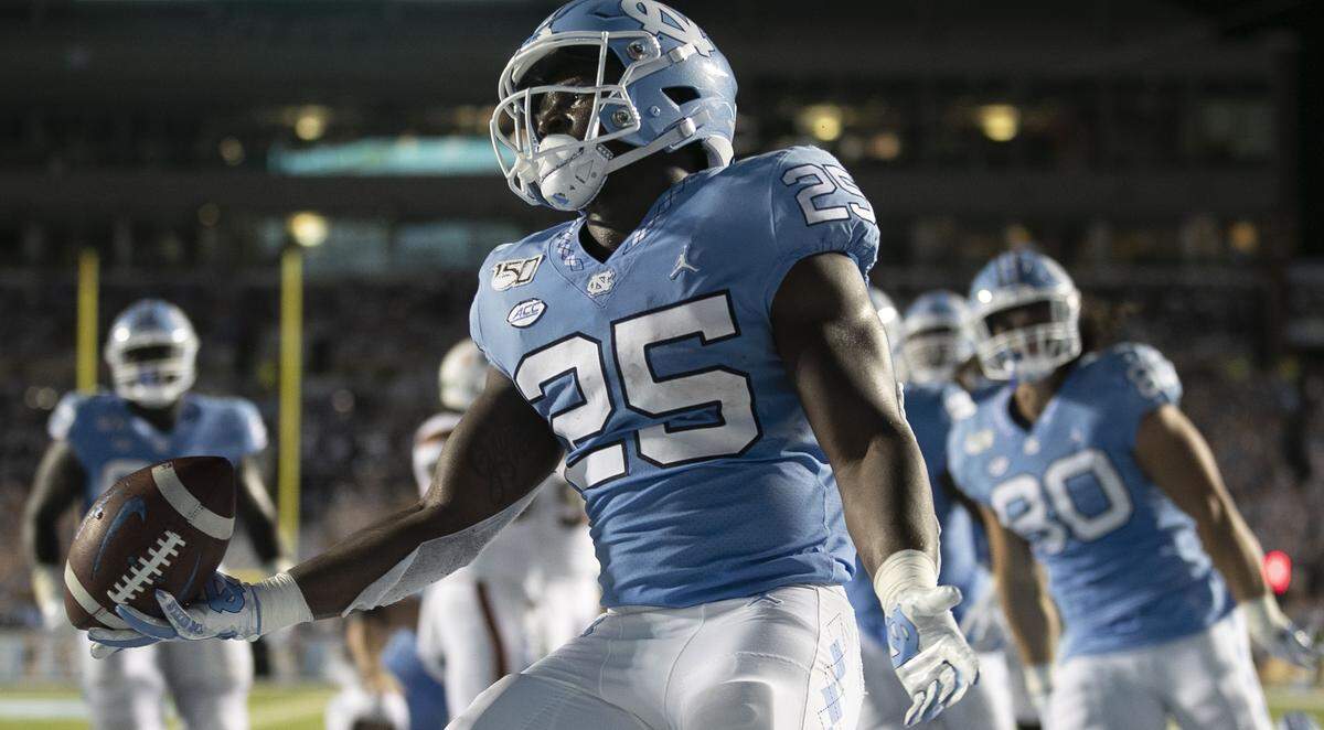 Javonte Williams (25) scores on a two-yard carry for a touchdown to give the Tar Heels a 17-3 lead over Miami in the first quarter on Saturday, September 7, 2019 at Kenan Stadium in Chapel Hill, N.C.