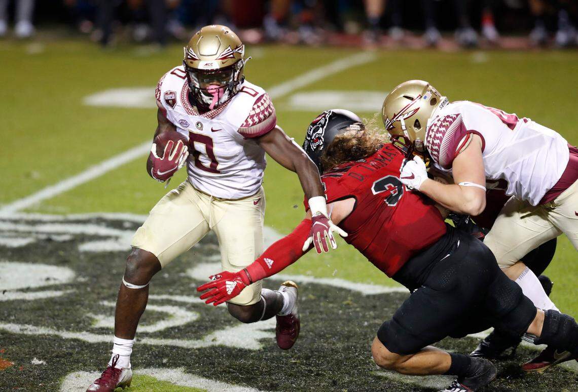 Florida State running back Jashaun Corbin (0) gets around N.C. State linebacker Drake Thomas (32) during the first half of N.C. State’s game against Florida State at Carter-Finley Stadium in Raleigh, N.C., Saturday, Nov. 14, 2020.
