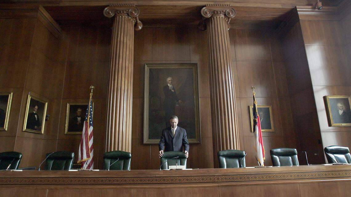 Court historian Danny Moody straightens the Chief Justice’s chair in the chambers of the Supreme Court of North Carolina