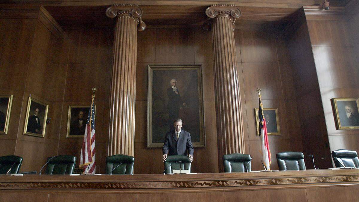 Court historian Danny Moody straightens the Chief Justice’s chair in the chambers of the Supreme Court of North Carolina