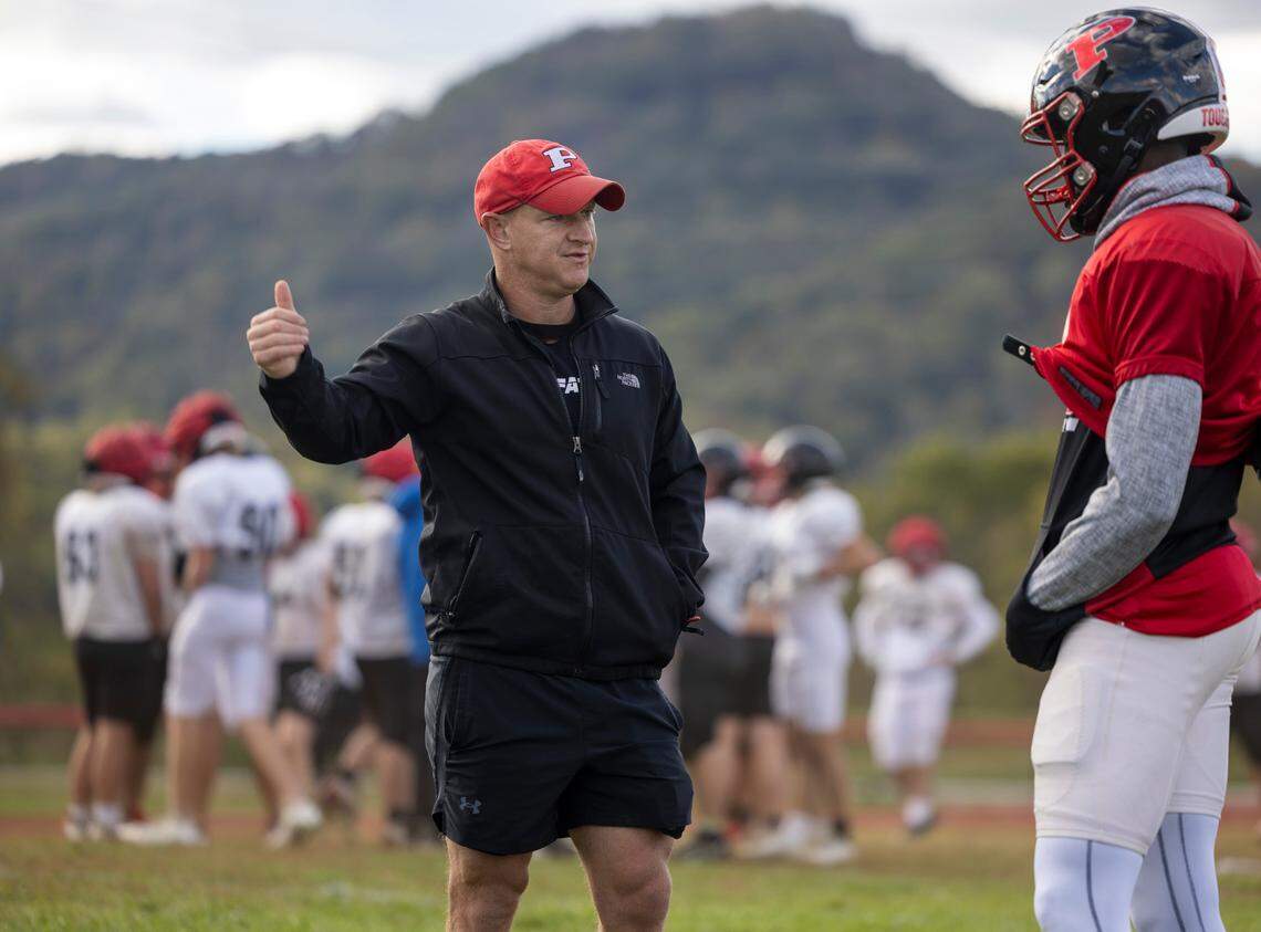 Pisgah High School football coach Ricky Brindley works with his team during practice on Wednesday, October 16, 2024 in Canton, N.C. Two of the team’s players lost their homes during Hurricane Helene. The team lost its home field, Pisgah Memorial Stadium from Pigeon River flooding.