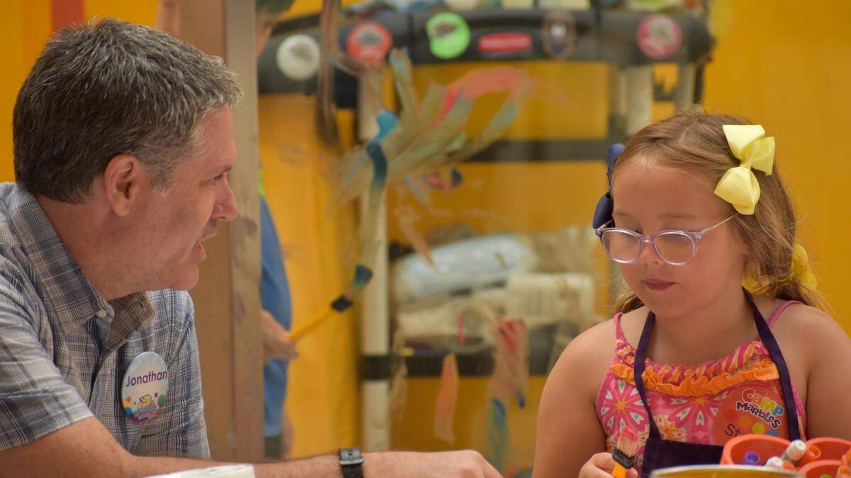 Jonathan Frederick, CEO of Marbles Kids Museum, talks to a summer camp participant at the imagiFAB exhibit. Frederick and museum leaders are navigating what a post-pandemic museum looks like.