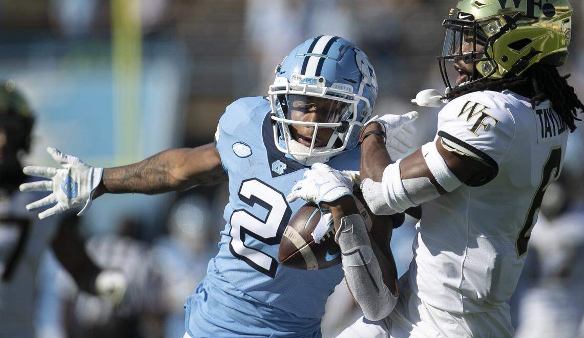 North Carolina’s Dyami Brown (2) pulls in a 54-yard pass from quarterback Sam Howell against the defense of Wake Forest’s Ja’Sir Taylor (6) in the first quarter at Kenan Stadium on Saturday, November 14, 2020 in Chapel Hill, N.C.