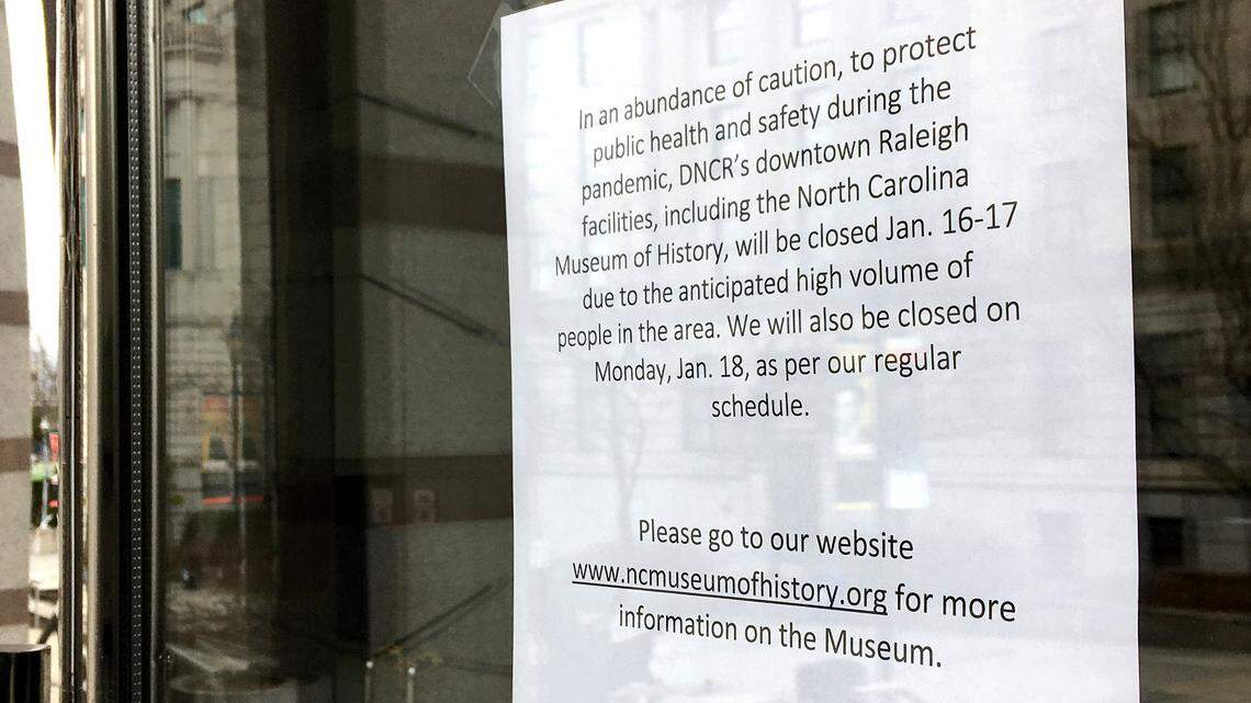 A sign at the entrance of the North Carolina Museum of History on Saturday, January 16, 2021, in Raleigh, N.C., announces their closure for the weekend.