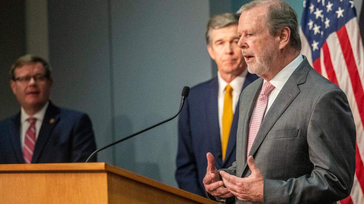 Senate leader Phil Berger speaks as House Speaker Tim Moore and Gov. Roy Cooper look on during a briefing on North Carolina’s coronavirus pandemic response Monday, May 4, 2020, at the NC Emergency Operations Center in Raleigh, N.C.