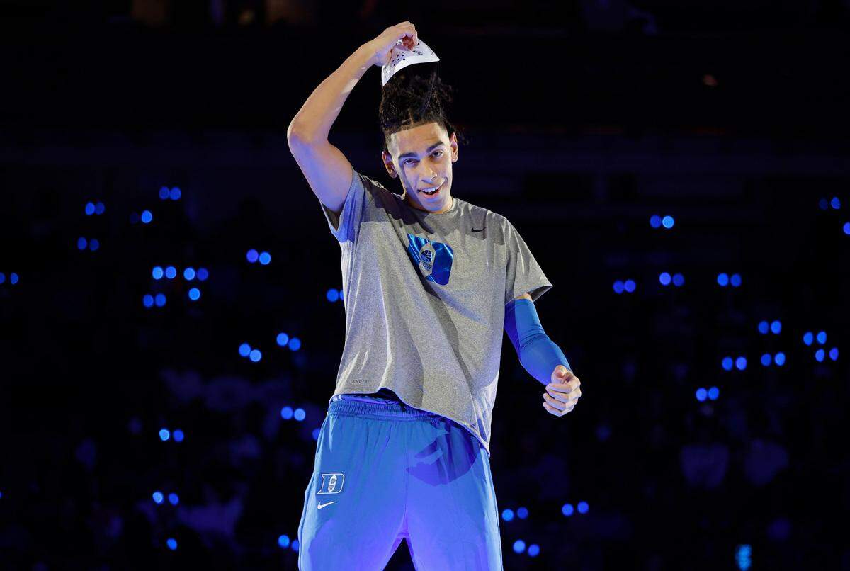 Duke’s Christian Reeves pulls off his mask after being introduced during Duke’s Countdown to Craziness at Cameron Indoor Stadium in Durham, N.C., Friday, Oct. 21, 2022.