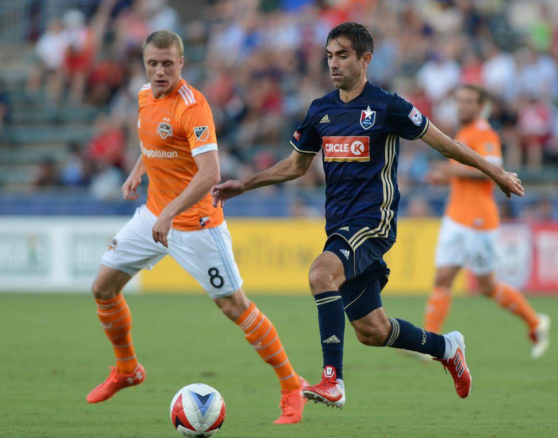 Austin Da Luz  (6) of North Carolina F.C. moves the ball against Joseph Holland (8) of Houston Dynamo during a 2017 game.