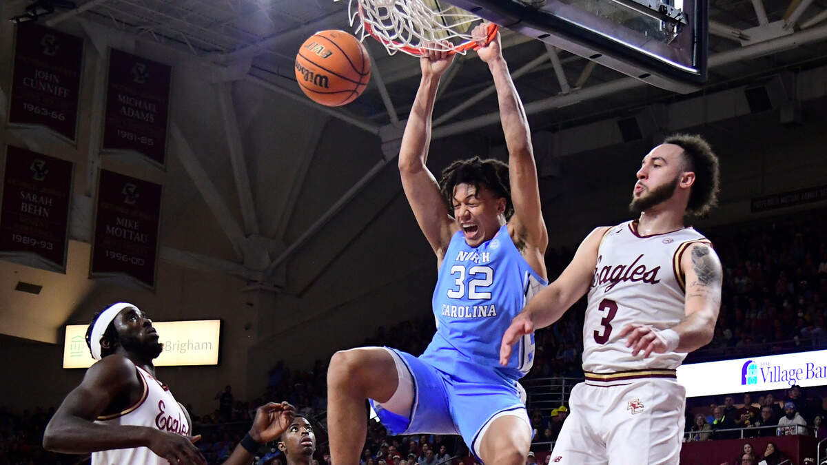 North Carolina Tar Heels forward James Okonkwo (32) hangs from the rim after making a basket against the Boston College Eagles during the first half at Conte Forum.