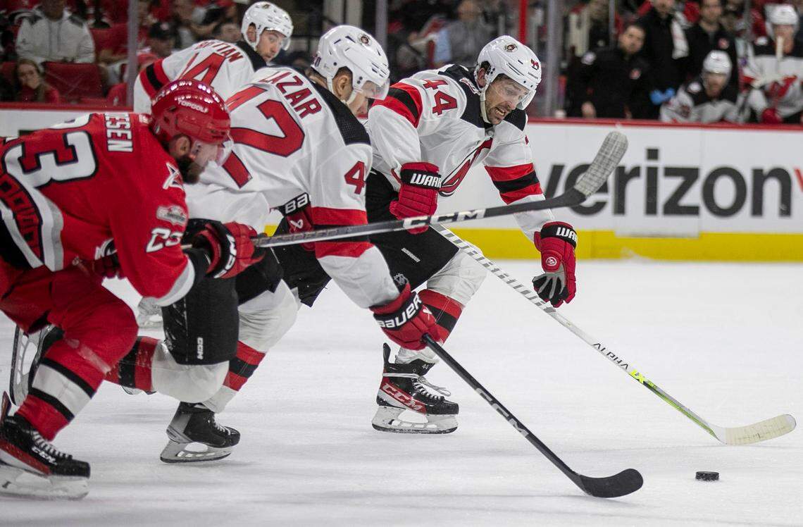 The New Jersey Devils Miles Wood (44), and Curtis Lazar (42) control the puck ahead of the Carolina Hurricanes Stefan Noesen (23) in the first period during Game 2 of their second round Stanley Cup playoff series on Friday, May 5, 2023 at PNC Arena in Raleigh, N.C.