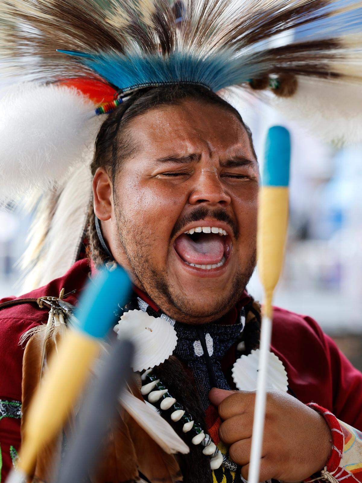 Isaiah Robinson of Asheboro, a member of Coharie Tribe, sings while performing in a drum group during the Dix Park Inter-Tribal Pow Wow in Raleigh, N.C., Saturday, August 26, 2023.