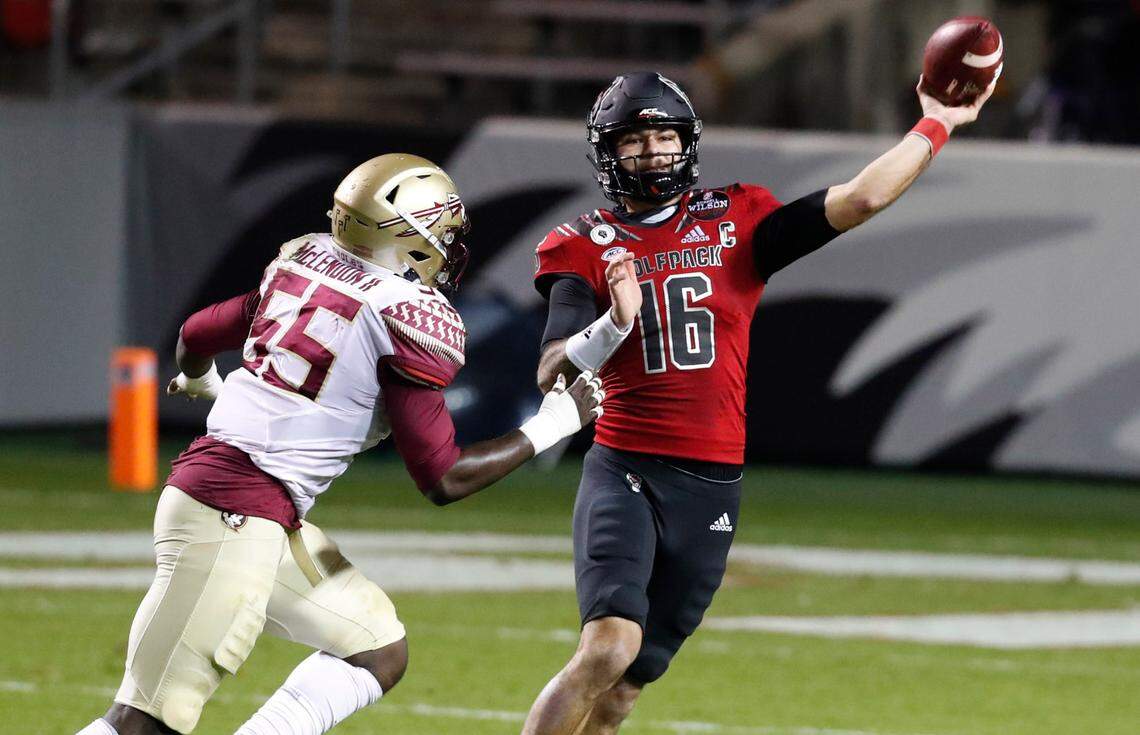 N.C. State quarterback Bailey Hockman (16) throws as Florida State defensive end Derrick McLendon II (55) pressures him during the first half of N.C. State’s game against Florida State at Carter-Finley Stadium in Raleigh, N.C., Saturday, Nov. 14, 2020.