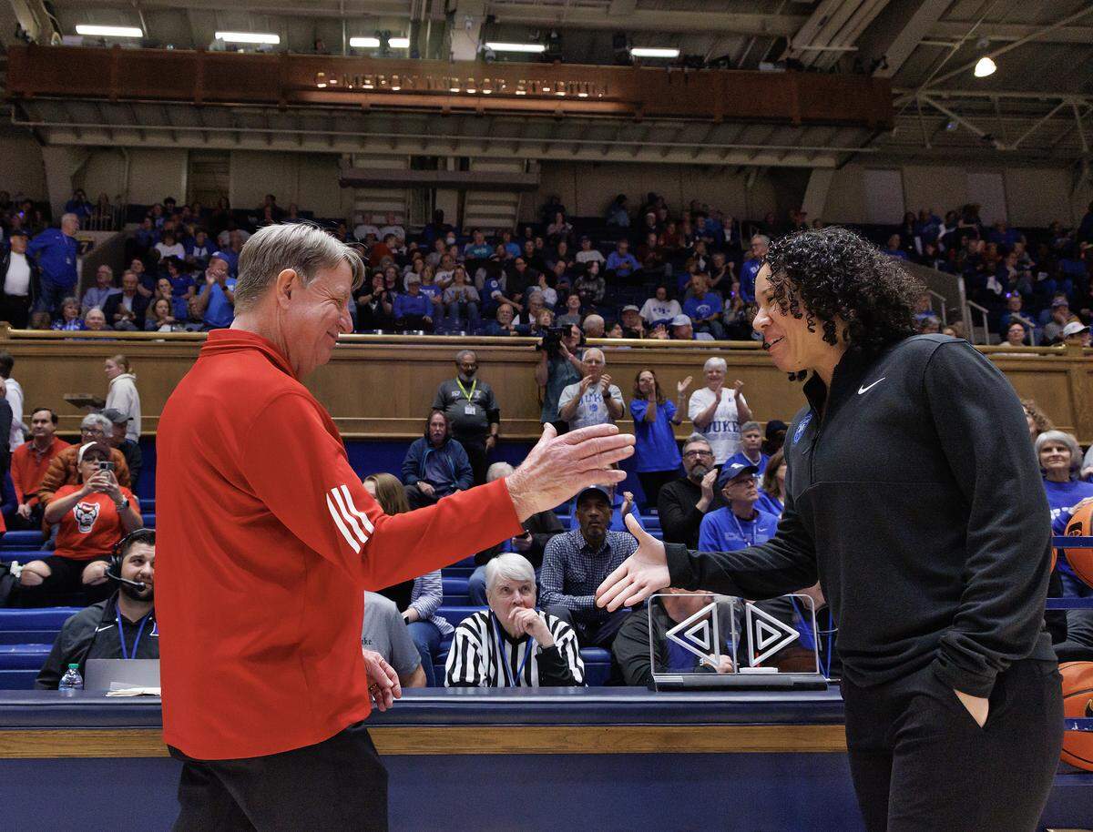 N.C. State head coach Wes Moore greets Duke head coach Kara Lawson prior to their teams’ matchup on Thursday, Feb. 19, 2026, at Cameron Indoor Stadium in Durham, N.C. 