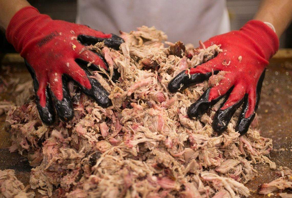 A Southern Smoke employee prepares the smoked pulled pork in the kitchenin Garland, N.C.