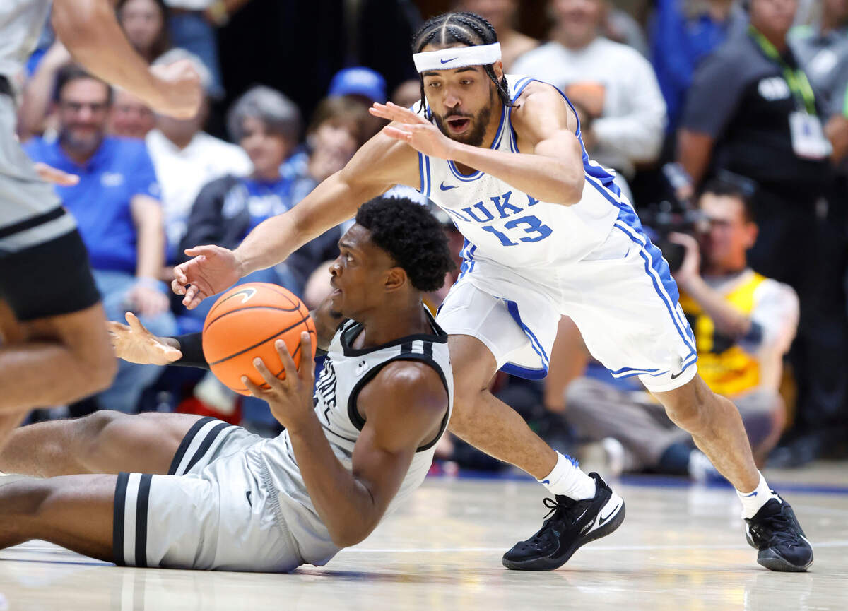 Duke’s Jacob Grandison (13) goes after the ball held by USC Upstate’s Khydarius Smith (0) during the first half of Duke’s game against USC Upstate at Cameron Indoor Stadium in Durham, N.C., Friday, Nov. 11, 2022.