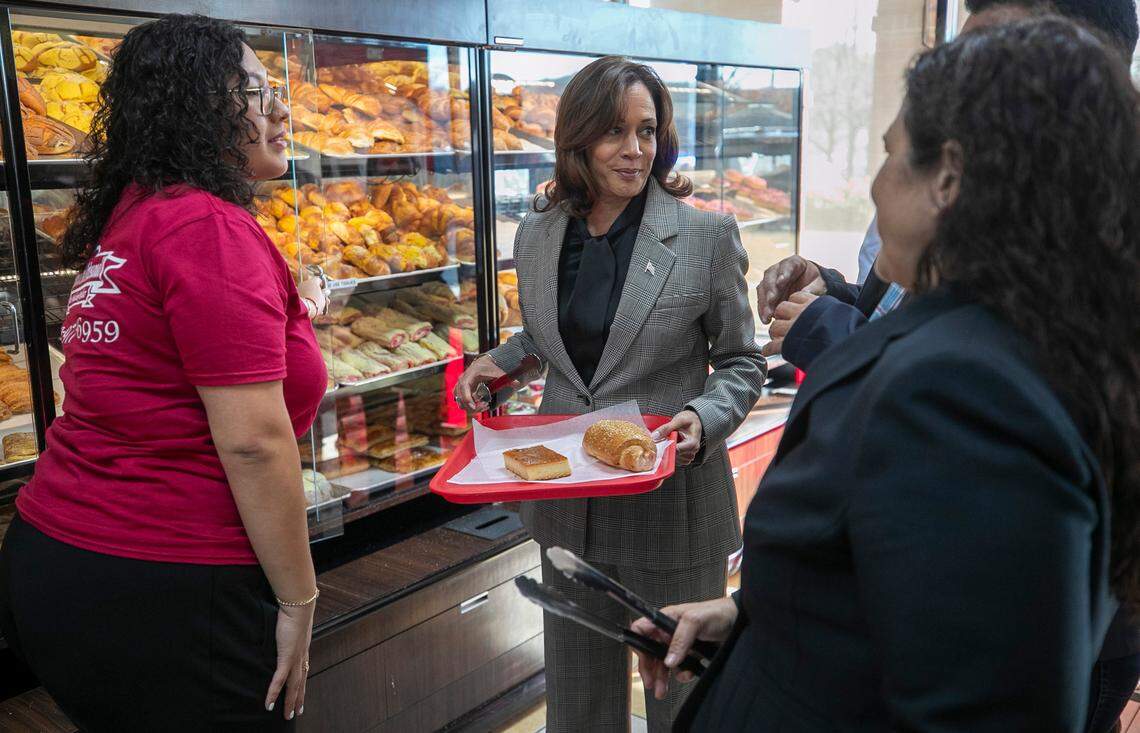 Astrid Sabillon, left, helps Vice President Kamala Harris during her visit to Panaderia Artisanal, a Latina-owned bakery on Monday, January 30, 2023 in Raleigh, N.C.