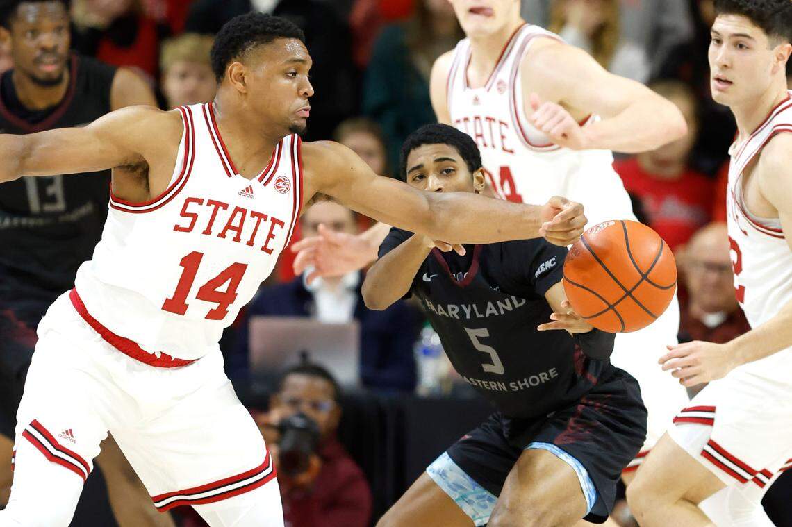 N.C. State’s Casey Morsell (14) steals the ball from Maryland Eastern Shore’s Damani Claxton (5) during the first half of N.C. State’s game against Maryland Eastern Shore at Reynolds Coliseum in Raleigh, N.C., Wednesday, Dec. 6, 2023.