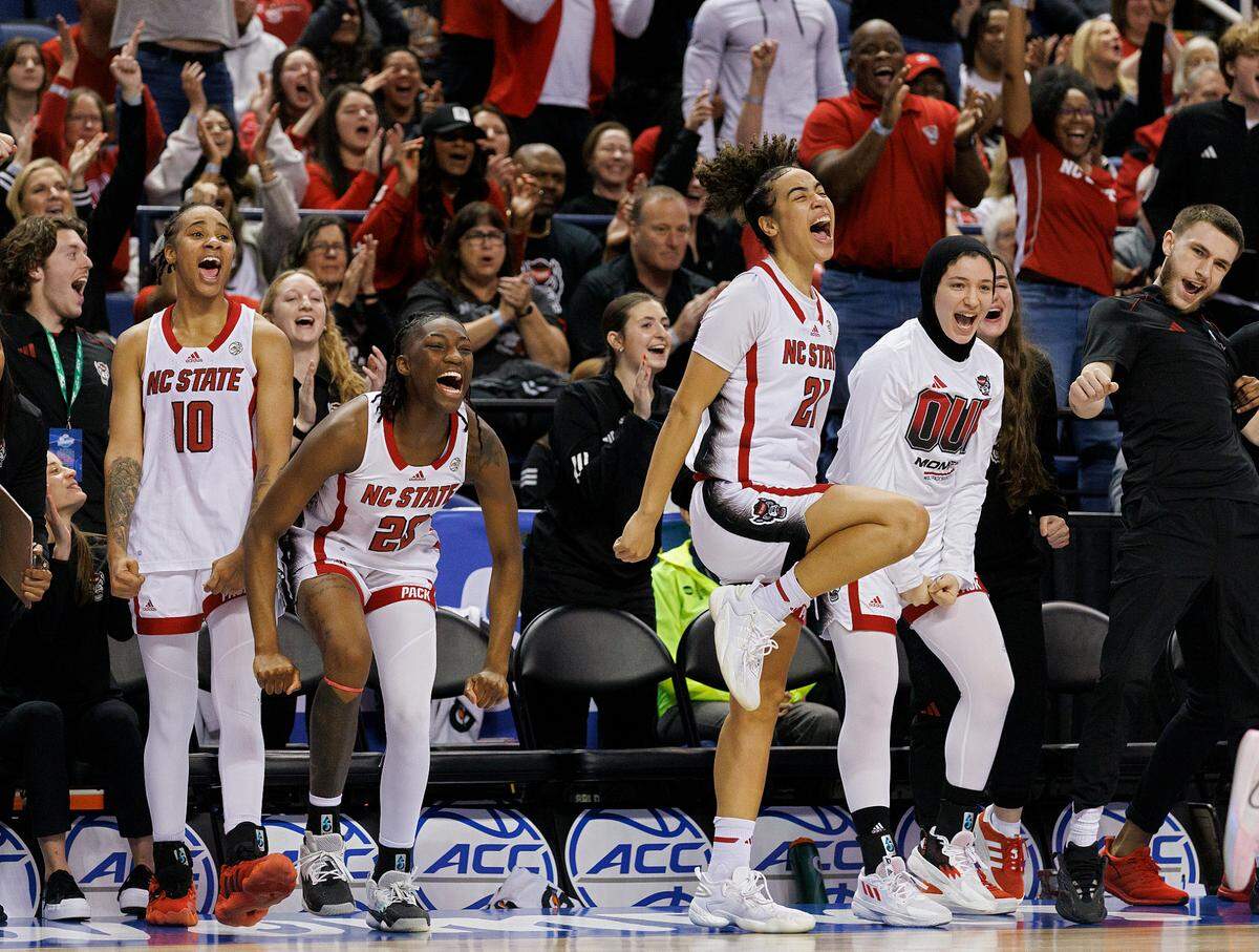 The N.C. State bench reacts in the closing minutes of the Wolfpack’s 69-43 win over Florida State in the ACC Tournament semifinals on Saturday, March 9, 2024, at Greensboro Coliseum in Greensboro, N.C.