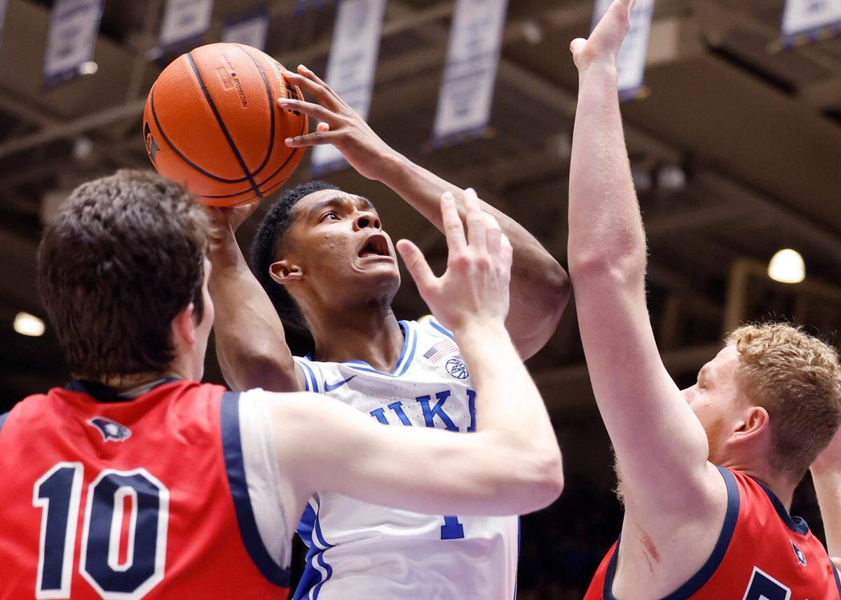 Duke’s Caleb Foster (1) shoots as Southern Indiana’s Nick Hittle (50) defends during the first half of Duke’s game against Southern Indiana at Cameron Indoor Stadium in Durham, N.C., Friday, Nov. 24, 2023.