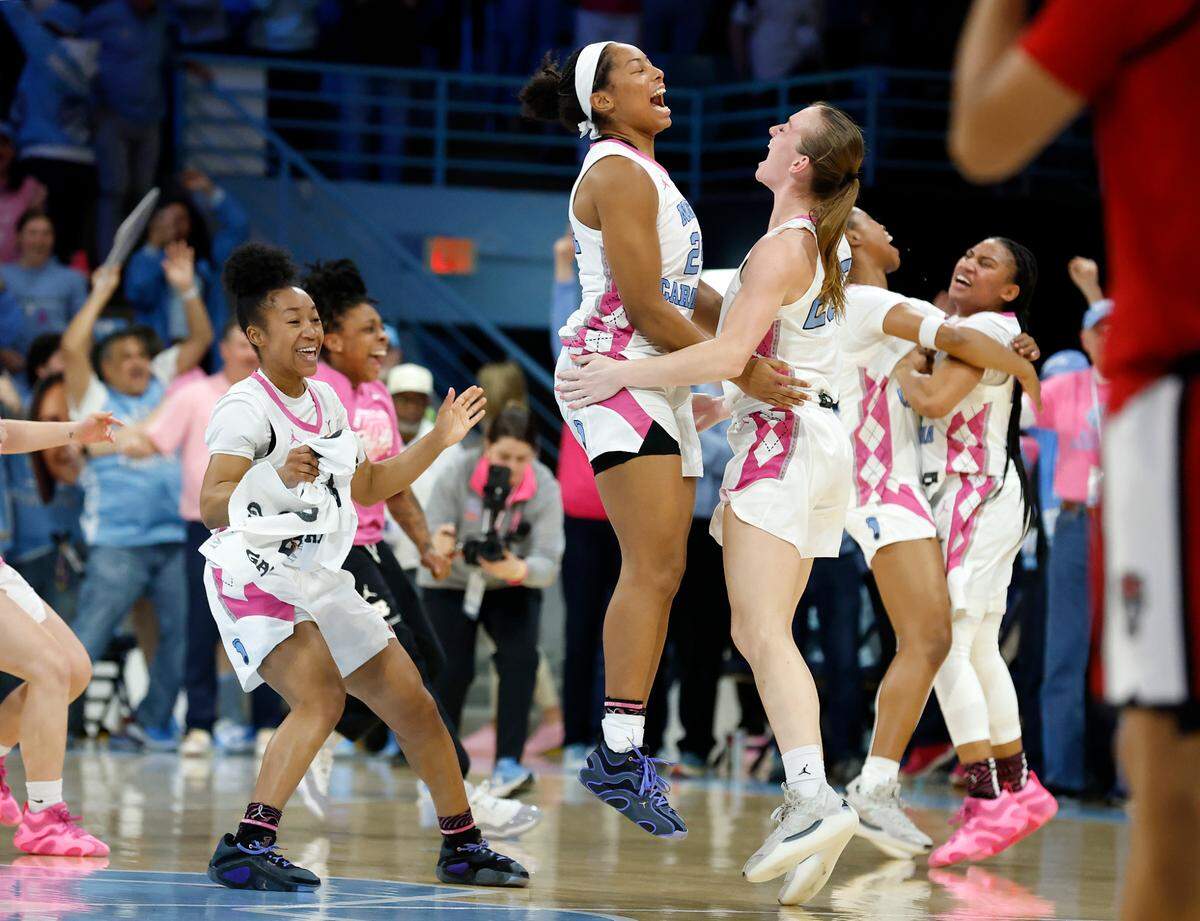 North Carolina’s Indya Nivar and Lexi Donarski, center, celebrate following the Tar Heels’ 66-65 win over N.C. State on Sunday, Feb. 16, 2025, at Carmichael Arena in Chapel Hill, N.C.