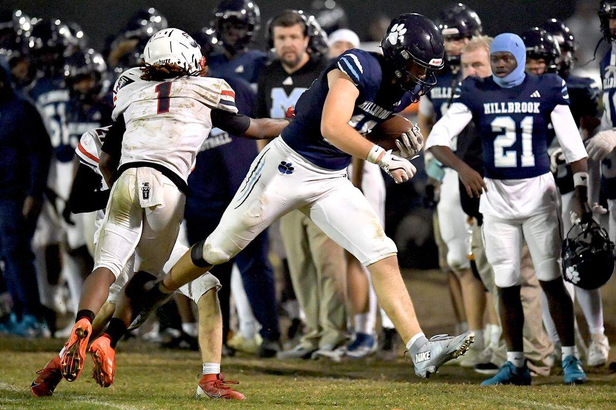 Millbrook tight end 	Hayes Brawner (18) runs out of bounds against Jordan's Jaleel Griffin (1) during the first half. The Millbrook Wildcats and the Jordan Falcons met in the third round of the NCHSAA 8A football playoffs in Raleigh, N.C. on November 21, 2025. 