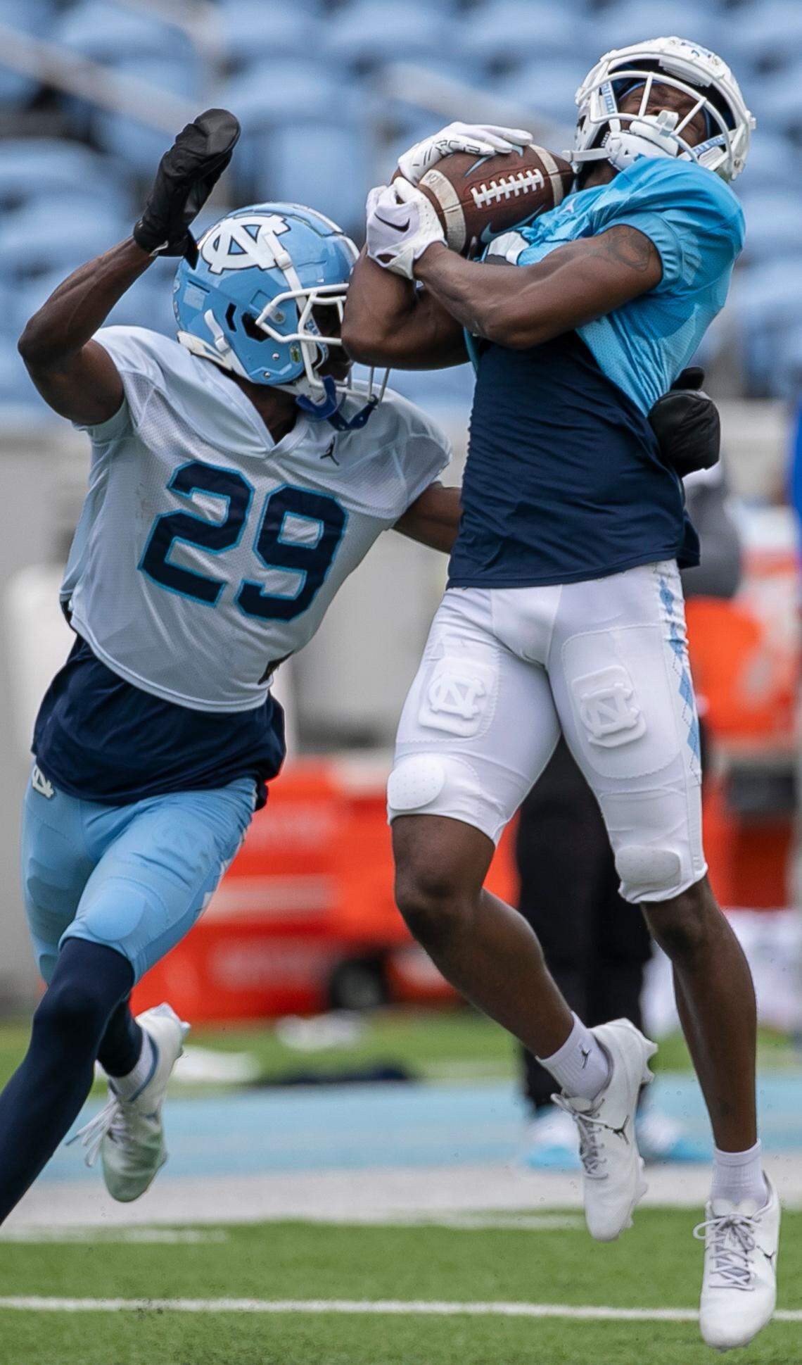 North Carolina wide receiver Devontez Walker (9) pulls in a pass from quarterback Drake Maye over defensive back Marcus Allen (29) during a scrimmage at the Tar Heels’ open practice on Saturday, March 25, 2023 at Kenan Stadium in Chapel Hill. N.C.