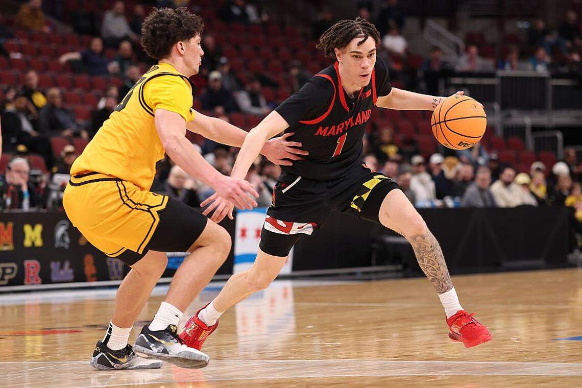 Darius Adams (1) of the Maryland Terrapins drives to the basket against Isaia Howard of the Iowa Hawkeyes in the 2026 Big Ten Men’s Basketball Tournament.