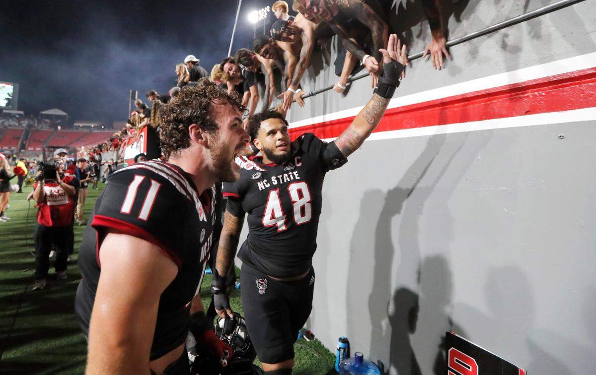 N.C. State linebacker Payton Wilson (11) celebrates with fans after the Wolfpack’s 27-14 victory over Texas Tech at Carter-Finley Stadium in September 2022.