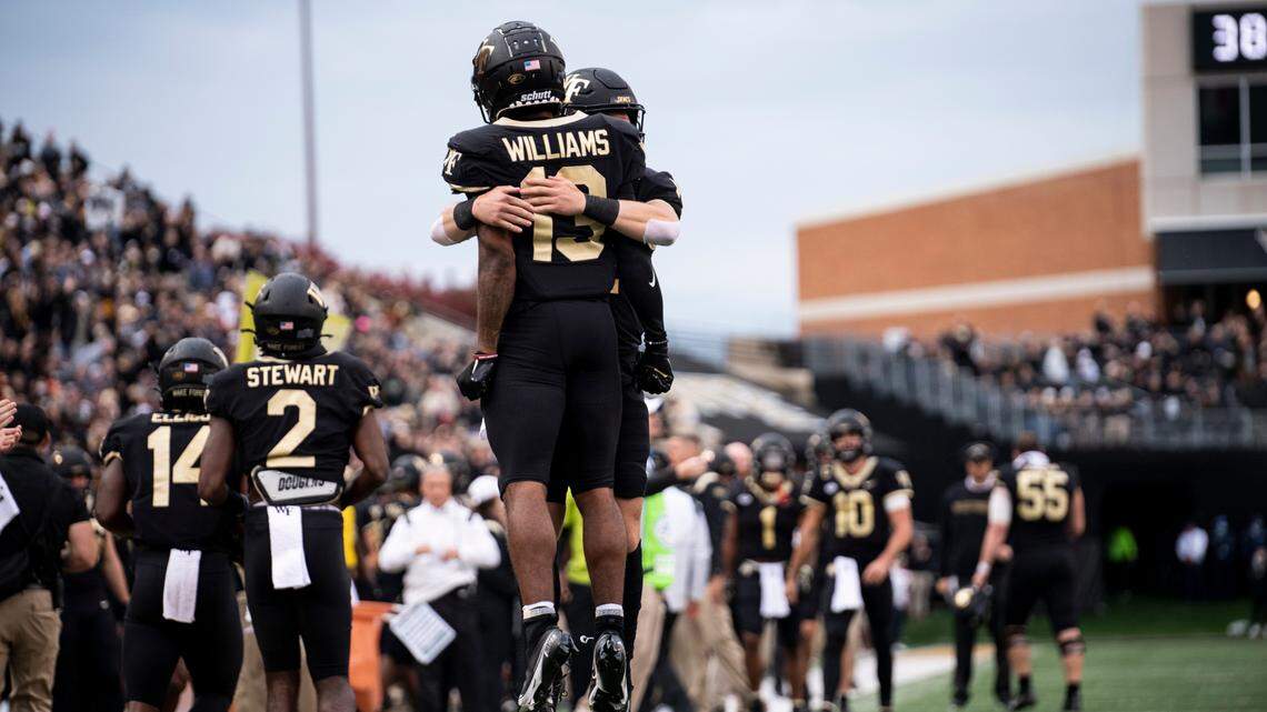 Wake Forest wide receiver Ke’Shawn Williams (13) and quarterback Mitch Griffis (12) celebrate a touchdown during the first half of Wake Forest’s 45-7 win over Duke on Saturday, Oct. 30, 2021, in Winston-Salem, N.C.