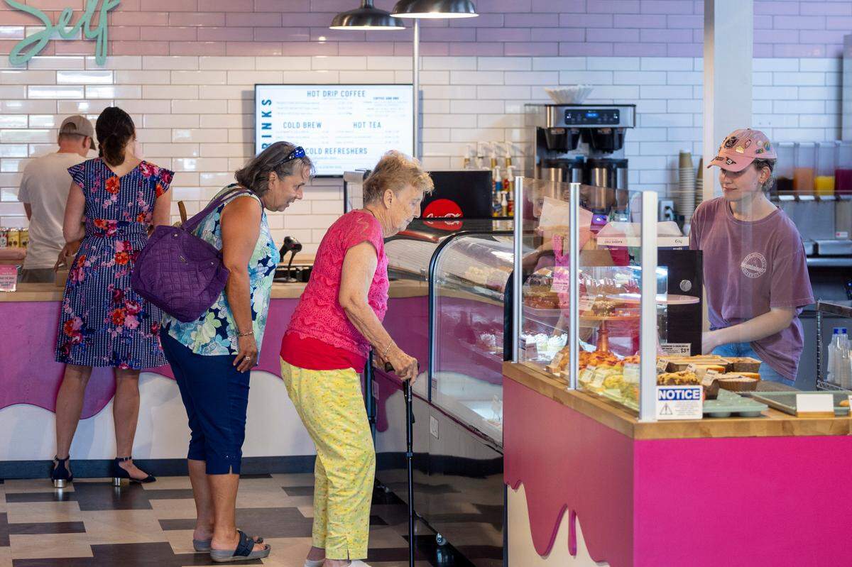 Customers look over some of the baked goods for sale at Treat Yo’ Self bakery in Wilson. Owner Greg Mason has more than 1 million TikTok followers and he and his husband Alex Mason started Wilson Pride.