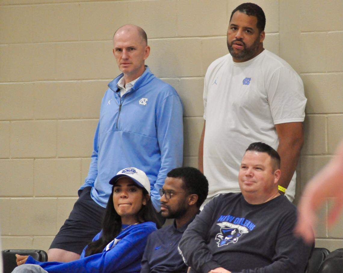 UNC assistant coaches Brad Frederick, standing left; and Sean May, standing right; hover over Duke men’s basketball general manager Rachel Baker, sitting left; and assistant coach Jai Lucas, sitting middle; while watching BABC forward T.J. Power play during Nike’s EYBL Peach Jam event in North Augusta, S.C., on Saturday, July 23.