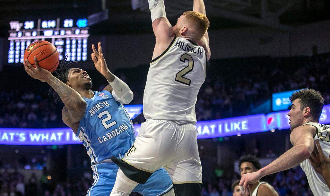 North Carolina’s Caleb Love (2) drives to the basket against Wake Forest’s Cameron Hildreth (2) in the first half on Tuesday, February 7, 2023 at Lawrence Joel Coliseum in Winston-Salem, N.C.