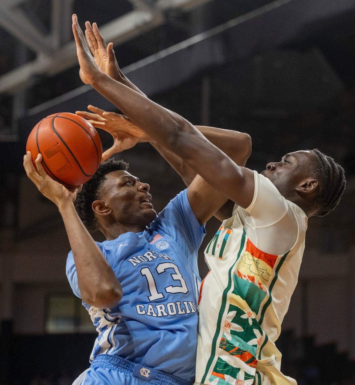 Miami’s Michael Nwoko (1) defends North Carolina’s Jalen Washington (13) in the second half on Saturday, February 10, 2024 at the Watsco Center in Coral Gables, Florida.