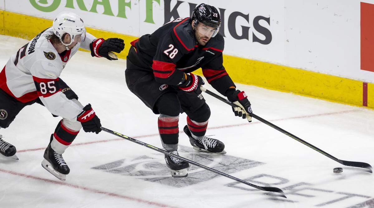 Carolina Hurricanes defenseman William Carrier (28) moves the puck ahead of Ottawa defenseman Jake Sanderson (85) in the first overtime period of Game 2 on Monday, April 20, 2026 during the first round of the Stanley Cup Playoffs at Lenovo Center in Raleigh, N.C. 