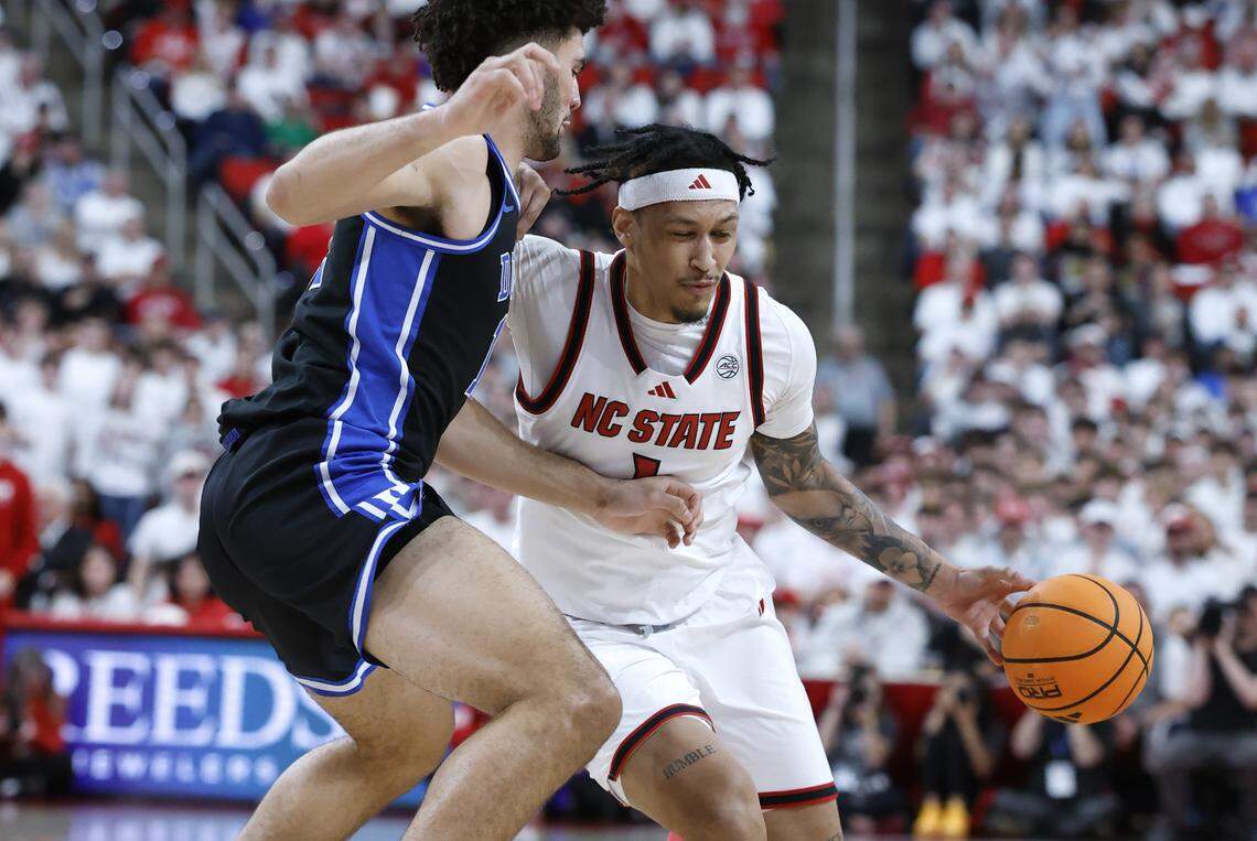 Duke’s Cameron Boozer (12) defends NC State's Darrion Williams (1) during the first half of Duke’s game against N.C. State at the Lenovo Center in Raleigh, N.C., Monday, March 2, 2026.