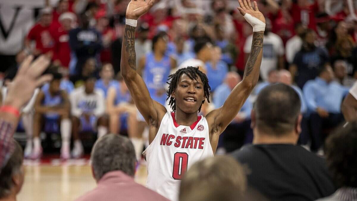 N.C. State’s Terquavion Smith (0) acknowledges the Wolfpack students section as the open a ten point lead over North Carolina the second half on Sunday, February 19, 2023 at PNC Arena in Raleigh, N.C.
