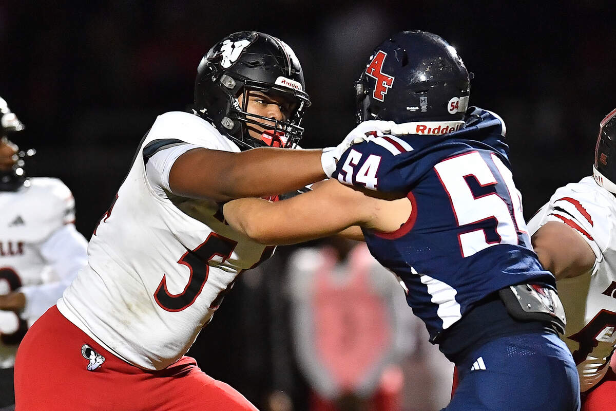 Rolesville defensive lineman Malachi Harris confronts Apex Friendship Jack Gentile (54) on the line of scrimmage during the first half. The Apex Friendship Patriots and the Rolesville Rams met in the second round of the NCHSAA 8A Playoff game in Apex, N.C. on Nov. 14, 2025.