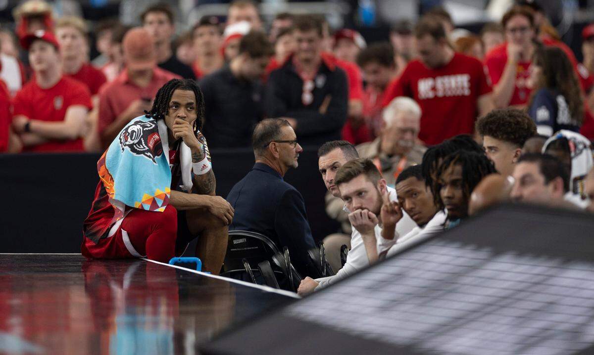 N.C. State’s Breon Pass (10) sits at the end of the bench as Purdue opens a 12 point lead over the Wolfpack in the second half during the NCAA Final Four National Semifinal game on Saturday, April 6, 2024 at State Farm Stadium in Glendale, AZ.