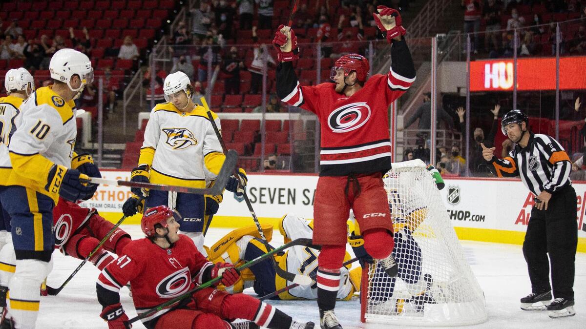 Carolina Hurricanes’ Steven Lorentz (78) celebrates after scoring on Nashville goalie Juuse Saros (74) in the first period to tie the Predators 1-1 on Tuesday, October 5, 2021 at PNC Arena in Raleigh, N.C.