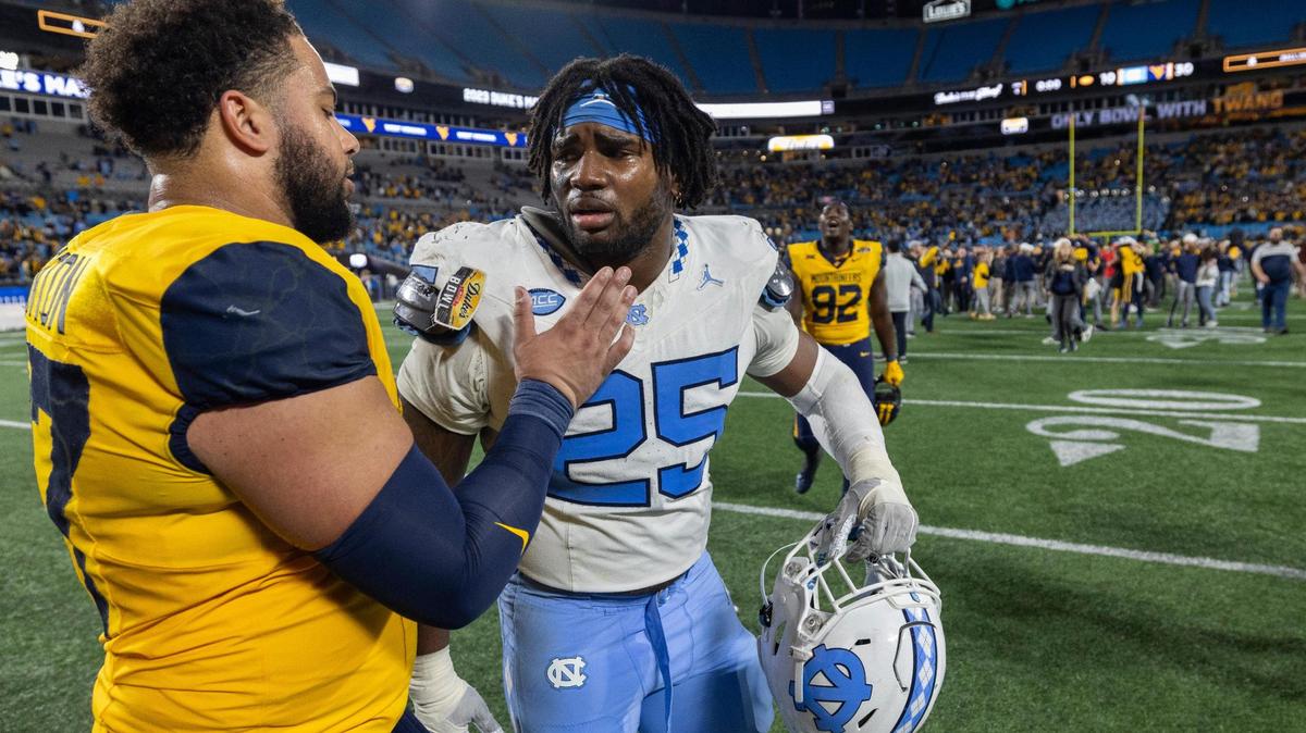 West Virginia’s Thornton Jalen (87) consoles North Carolina’s Kaimon Rucker (25) following the Mountaineers’ 30-10 victory in the Duke’s Mayo Bowl on Wednesday, December 27, 2023 at Bank of American Stadium in Charlotte, N.C.