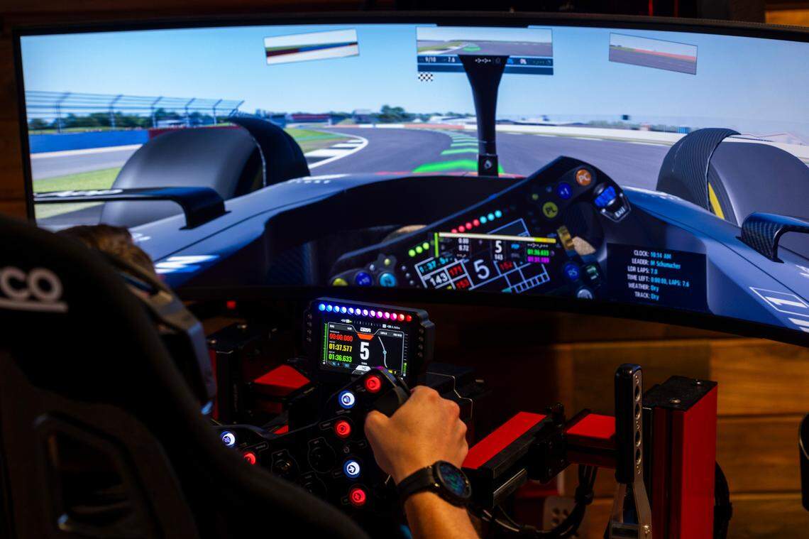 Maverick Bostic drives a racing simulator at Apex Racing Lab on Saturday, July, 13, 2024. There are 16 simulators, with 12 for adults and four for children.