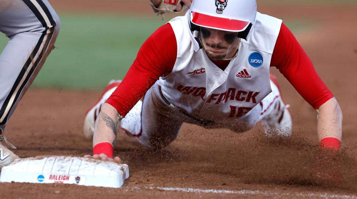 N.C. State’s Eli Serrano III (16) dives safely back to first base during N.C. State’s 9-2 victory over Bryant in the NCAA Raleigh Regional at Doak Field Friday, May 31, 2024.