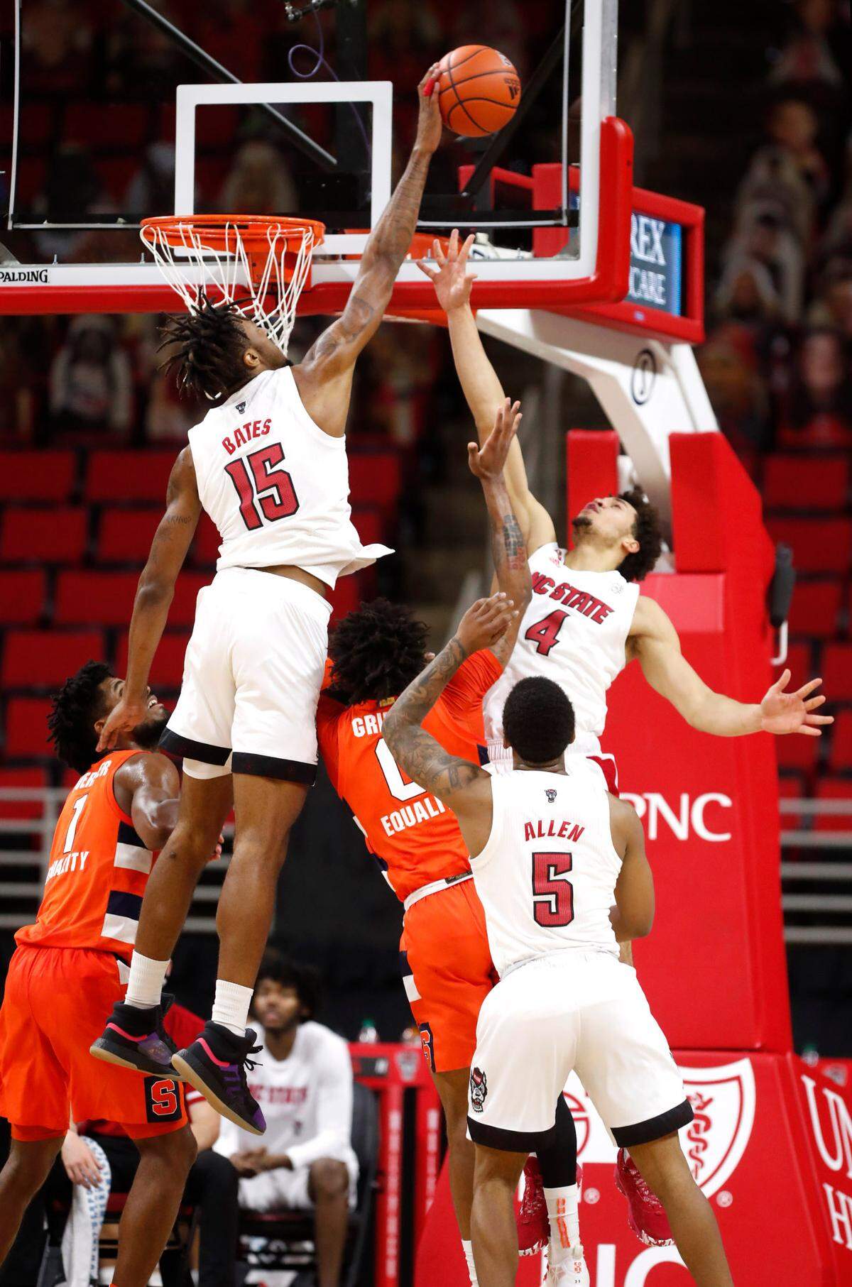 N.C. State’s Manny Bates (15) blocks the shot by Syracuse’s Alan Griffin (0) during the first half of N.C. State’s game against Syracuse at PNC Arena in Raleigh, N.C., Tuesday, February 9, 2021.