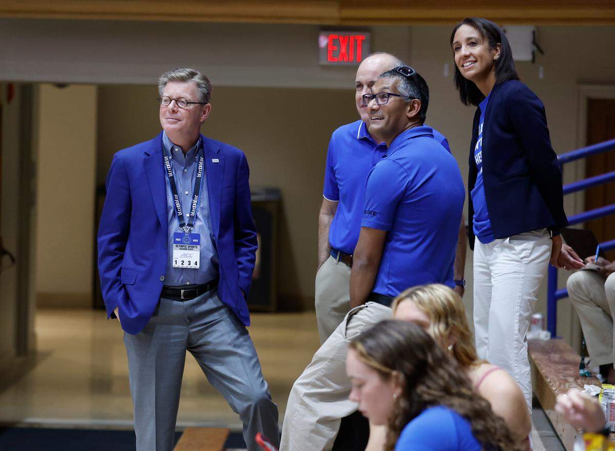 Duke President Vincent Price, left, and athletics director Nina King, right, watch warmups before Duke volleyball’s game against East Tennessee State University in the Duke Invitational at Cameron Indoor Stadium in Durham, N.C., Friday, Sept. 2, 2022.