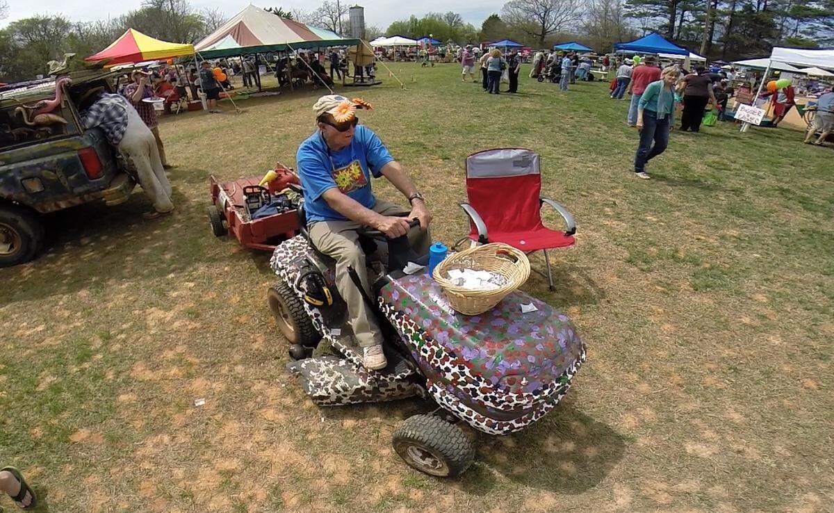 On April 5, 2014, Clyde Jones sat on his custom decorated riding lawnmower as he awaited “customers" to get his water transfer tattoos during the 13th annual ClydeFEST Kids Carnival of Folk Art, which honors him and his work in Bynum. 