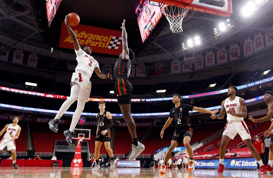 N.C. State’s Cam Hayes (3) shoots as Miami’s Nysier Brooks (3) defends during Miami’s 64-59 victory over N.C. State at PNC Arena in Raleigh, N.C., Saturday, January 9, 2021.
